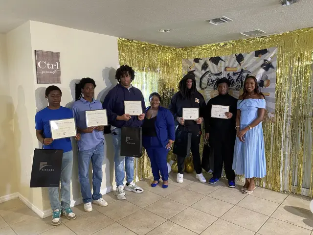 Tech innovation program graduates displaying completion certificates
